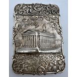 A Victorian silver castle-top card case. The Royal Exchange London in high relief with a foliage
