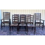 Eight rush seated ladder backed dining chairs, 2 carvers, 6 side chairs.