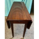 A mahogany drop leaf table with drawer and castors. 74 h x 121 w x 92cm, closed 45cm w.