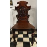 A Victorian mahogany hall chair. Ht to back 90cm, ht to seat 43cm width at front 45cm.