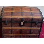 A 19thC dome topped wooden bound trunk with metal fittings and leather carrying handles. 88 w x 50 d
