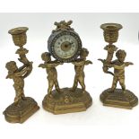 Ormolu clock garniture. 20cm h. Two cherub candlesticks and clock with enamelled face.