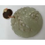 A Chinese carved jade pendant with wax seal 5.5cm d.