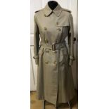 A vintage Burberry ladies trench coat with belt size 12 petite.