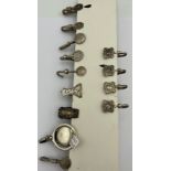 Nine hallmarked silver napkin holders, various dates and makers together with four marked sterling.