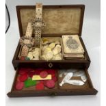 A 19thC mahogany gaming box and contents to include De La Rue & Co playing cards, bone markers,
