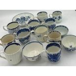 A collection of 18thC blue and white cups, cans and saucers, both pottery and porcelain.