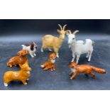 A collection of Beswick animals to include two foxes (one sitting), three dogs spaniel, dachshund,