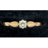 Solitaire diamond ring set in yellow metal, marks rubbed. 1.2 gm total weight. Size O.
