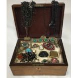 A box measuring 25.5cm x 19cm x 11.5cm containing a quantity of costume jewellery brooches, one jet,