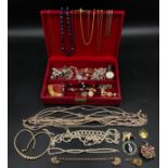 A jewellery box containing a selection of costume jewellery to include mainly necklaces some