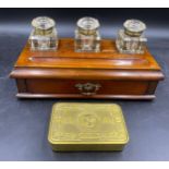 A mahogany inkstand with drawer and three glass bottles with brass hinges etched to top, Copy G, Red