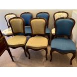 Seven French mahogany and ormolu mounted cabriole legged salon chairs. Upholstered variously,