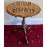 A 19thC chess table on tripod base together with Battle of Waterloo metal chess set. 52 d x 56cm h.