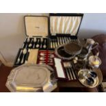 A quantity of silver plated cutlery etc to include boxed spoons, lidded tureen, bottle stands and