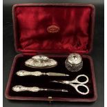 A hallmarked silver mounted five piece vanity set with Art Nouveau and iris decoration, Birmingham