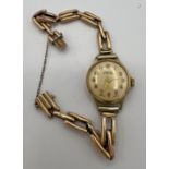 An Ingersoll 9 carat gold ladies wristwatch on a 9 carat gold bracelet. Total weight 14.8gm.