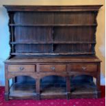 A 19thC oak 3 drawer dresser with rack to back. 180 h x 185 w x 43cm d.
