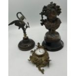 Nineteenth century bronze figure, brass wall mounted clock and a metal figure of heron and snake