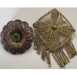 Two brooches to include a white metal round Indian brooch set with rubies, emeralds and clear stones