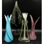 A collection of four pieces of studio glass to include three vases and one leaf shaped display piece