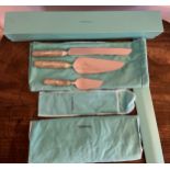 A Tiffany and Co. Chrysanthemum pattern cake knife 31cm l and two cake slices in protective covers
