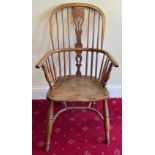 A 19thC high back Windsor armchair with crinoline stretcher. 100 h x 55cm w.