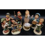 Goebel figures to include wash day, young boy skiing, post boy, little boy singing from music sheet,