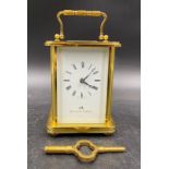 A Swiss brass-cased carriage clock for Matthew Norman Retailers, London with visible escapement