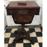 A mahogany ladies sewing table, with compartmental drawer over a tapering wool drawer, on turned