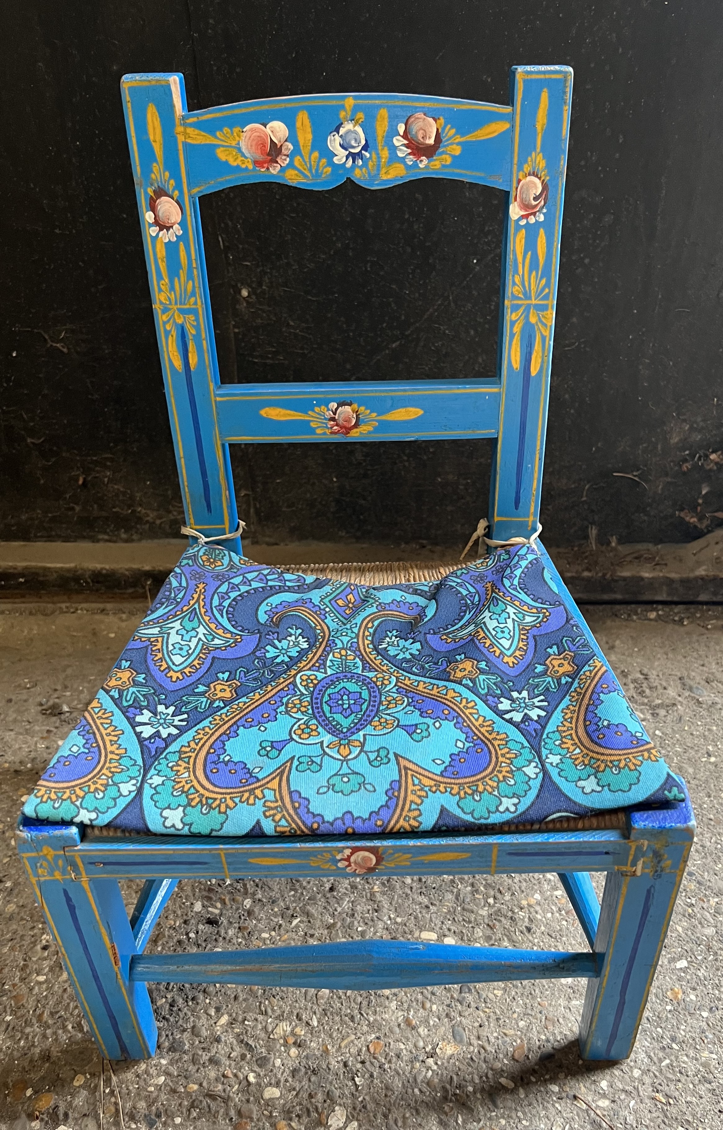 A painted child's chair with rushed seat. 22 h to seat, 47cm h to back.