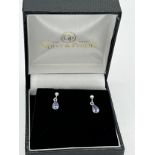 Eighteen carat white gold earrings set with purple stones.