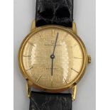 An automatic 9ct gold cased Universal Geneve wristwatch with gold coloured face. Winds and goes.