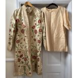 A good quality Indian embroidered long length silk jacket on cream background with split sides