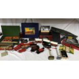 A collection of Hornby trains along with tracks and homemade buildings, bridges and stations. Hornby