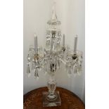 A four branch glass candelabra with pendant lustre drops. 65cm h.