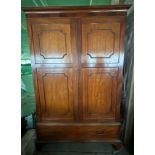 An Edwardian mahogany wardrobe with drawer to base, bracket feet, brass rail and hooks to