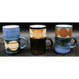 A collection of three Troika mugs to include one by Avril Bennett signed A B to base, one by Marilyn