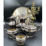 A silverplated tea and coffee set with unassociated tray and a brass four branch candelabra.