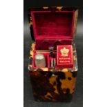 A tortoise shell etui sewing kit in a square shaped form with a small engraved cartouche to top