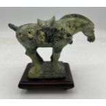 A Chinese soapstone Tang horse, 11cm h on wooden stand.