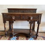 A 19thC carved oak hall table with two drawers to front and raised upstand to back. 106 w x 91 h x