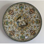 A massive polychrome maiolica charger with classical scene surrounded by band of grotteschi. 60cm d