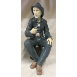 A large Nao figure modelled as a fisherman seated smoking a pipe, 39cm h.