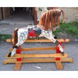 A 20thC rocking horse overall length 167cm, height to saddle 90cm.