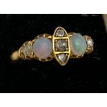 An 18 carat gold, opal and diamond ring. Weight 3gm. Size Q.