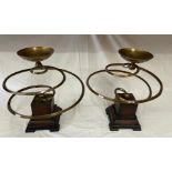 A pair of 20thC candle stands by Austin with brass spiral design on wooden bases.