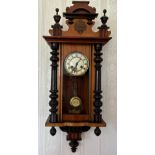 A mahogany wall clock with white enamel dial. 88 h x 37cm w approx.