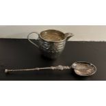 An anointing spoon by Levi and Salaman, Birmingham 1901, a miniature embossed silver jug