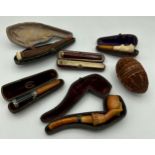 Various meerschaum pipes to include wood and amber together with a treen egg.